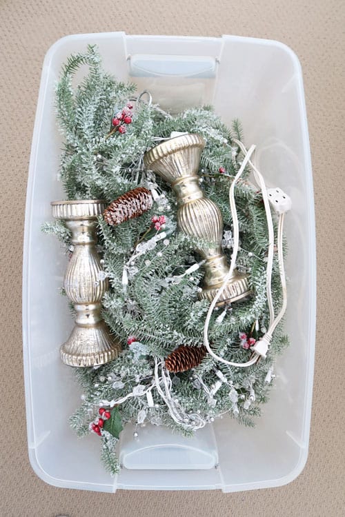christmas decorations placed in a clear storage bin