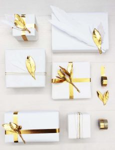 holiday gift wrap with white paper and gold embellishments