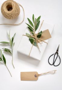 simple gift wrap with white paper twine and green sprigs