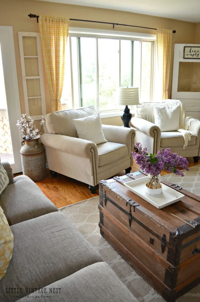 French farmhouse style living room with neutral colors and wooden trunk coffee table