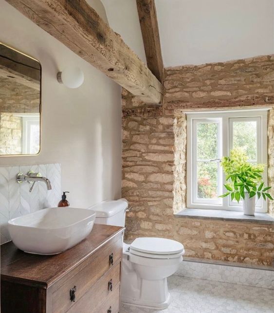 Farmhouse home decor ideas for the bathroom with stone wall and exposed rafter