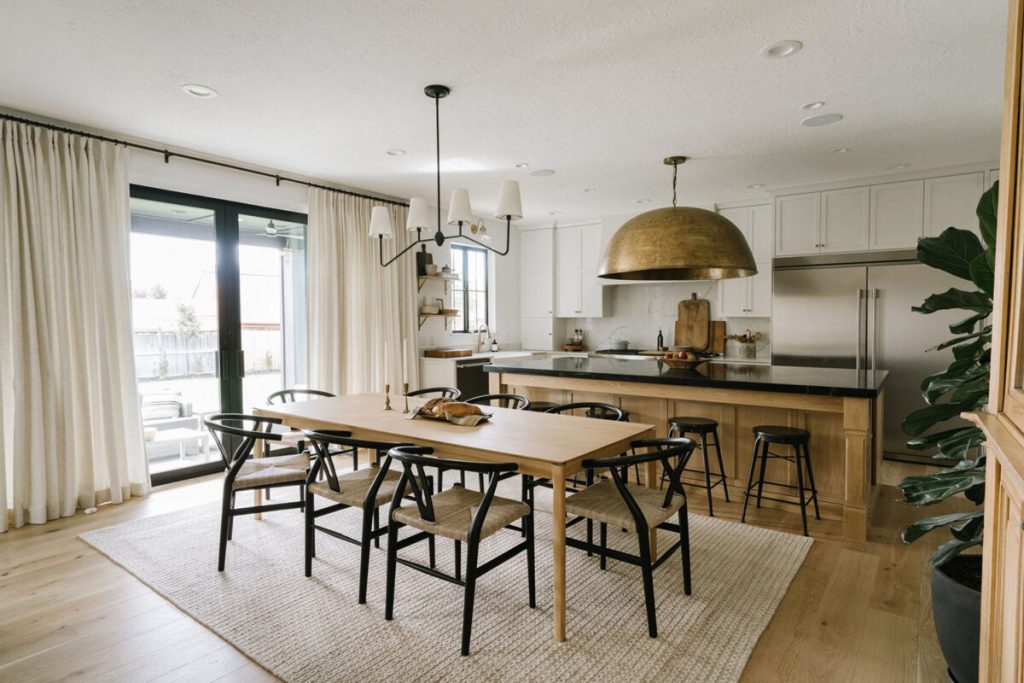 Modern farmhouse kitchen with hammered metallic pendant light, black detailing, woven textures and a balance between rustic and refined surfaces for farmhouse decor ideas